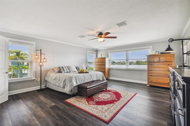 bedroom featuring multiple windows, dark hardwood / wood-style floors, ceiling fan, and ornamental molding