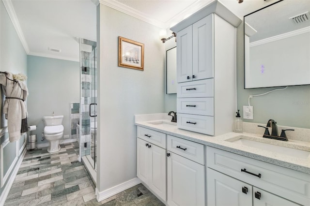 bathroom featuring tile patterned flooring, a shower with door, toilet, dual vanity, and ornamental molding