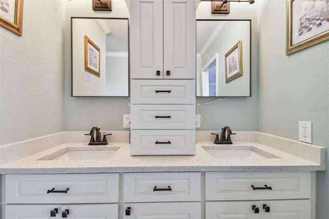 bathroom featuring double sink vanity and crown molding