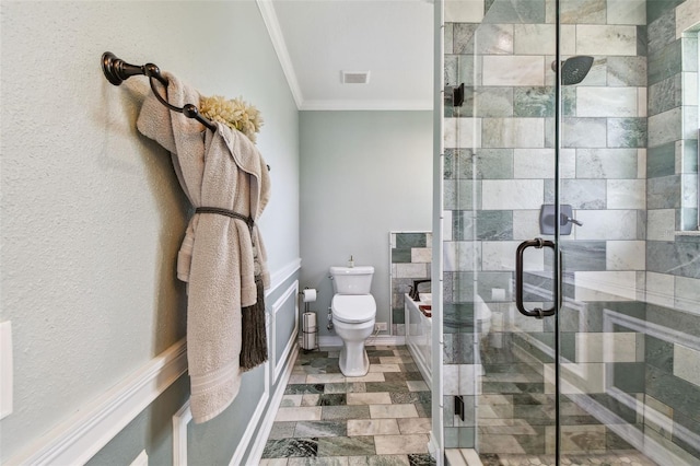 bathroom featuring tile patterned floors, a shower with door, crown molding, and toilet