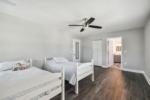 bedroom with ensuite bath, ceiling fan, hardwood / wood-style flooring, and a closet