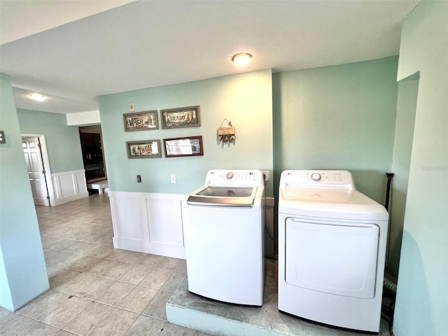 laundry room featuring independent washer and dryer and light tile patterned floors