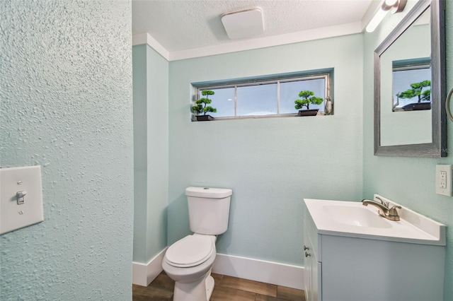 bathroom with vanity, a textured ceiling, and toilet