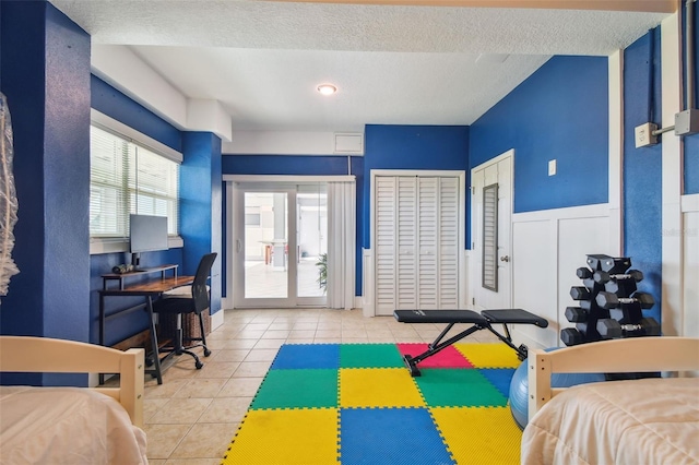 tiled bedroom featuring a textured ceiling