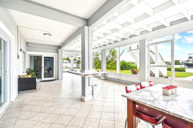 sunroom featuring beamed ceiling and coffered ceiling