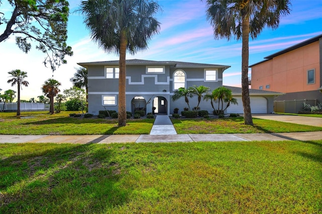 view of front facade featuring a garage and a front yard