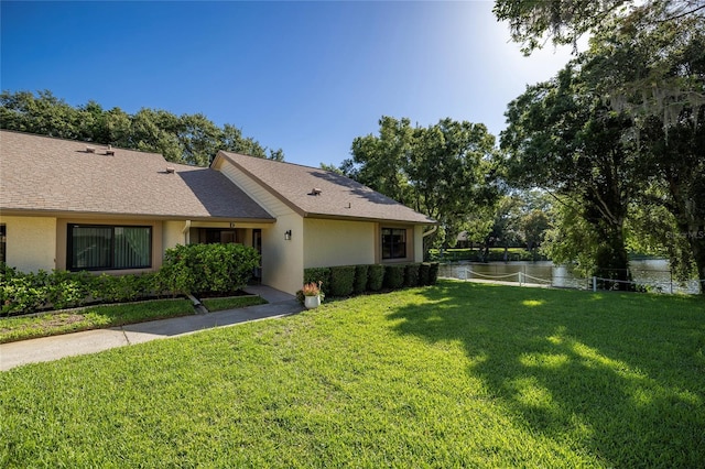 exterior space with a water view and a front yard