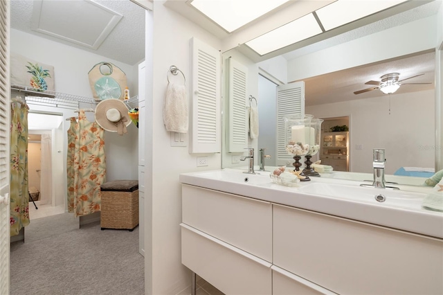 bathroom with vanity, curtained shower, and ceiling fan