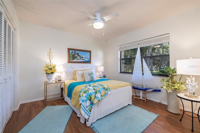 bedroom featuring hardwood / wood-style floors, a closet, a textured ceiling, and ceiling fan