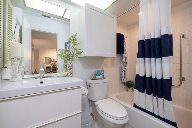 full bathroom with vanity, shower / tub combo, and toilet