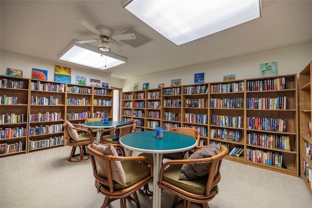 interior space with ceiling fan