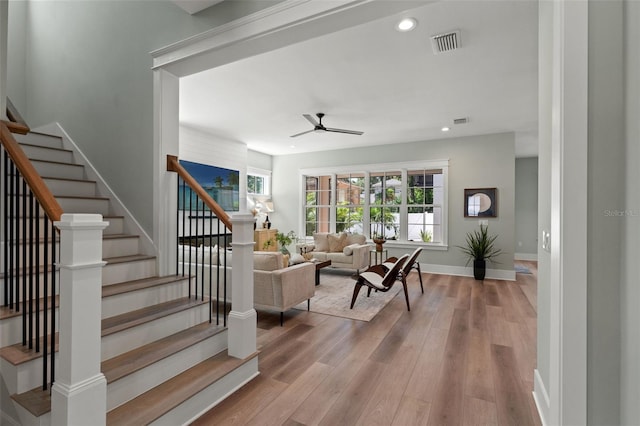 living room featuring light wood-type flooring and ceiling fan