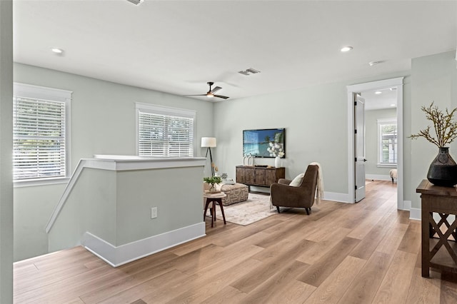 living room featuring ceiling fan and light wood-type flooring