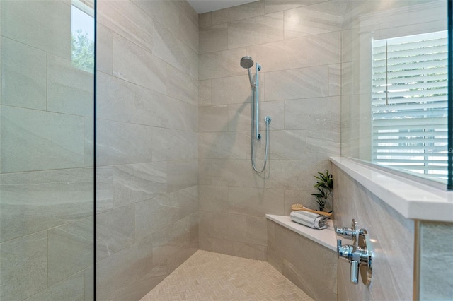 bathroom with a tile shower