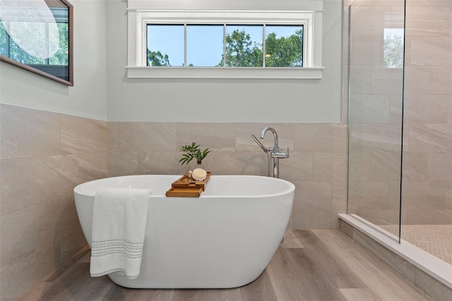 bathroom with tile walls and a bathing tub