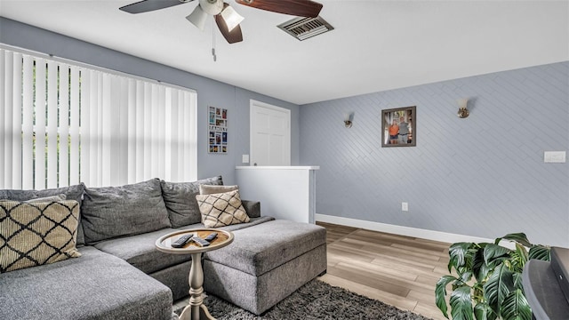 living room featuring hardwood / wood-style flooring and ceiling fan