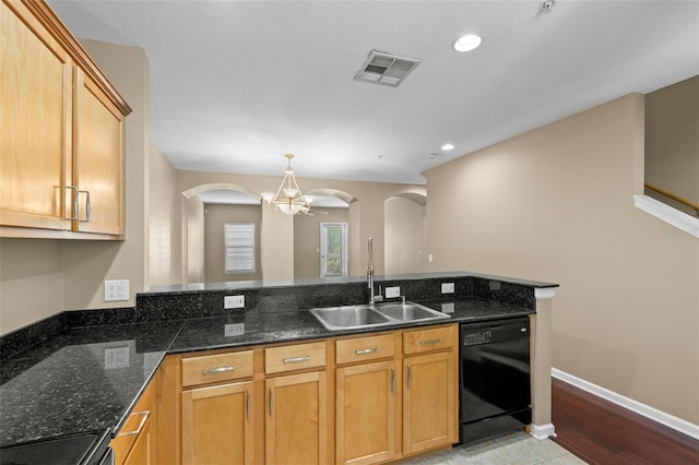 kitchen with light tile patterned flooring, pendant lighting, sink, dark stone countertops, and black appliances