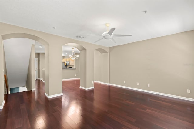 unfurnished room with dark wood-type flooring and ceiling fan