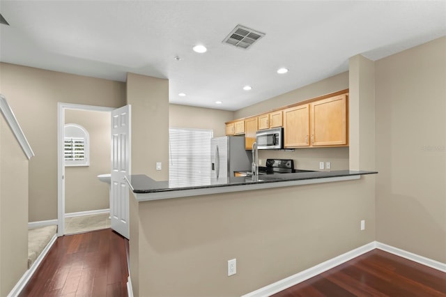 kitchen featuring stainless steel appliances, dark wood-type flooring, light brown cabinetry, and kitchen peninsula