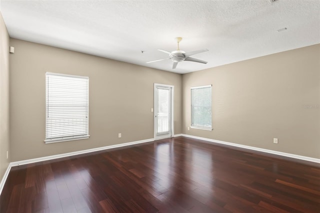 empty room with hardwood / wood-style floors, a textured ceiling, and ceiling fan