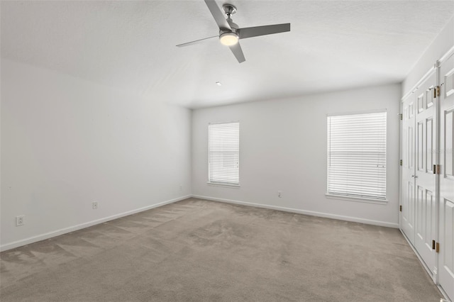 carpeted empty room featuring ceiling fan