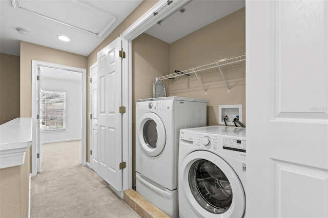 clothes washing area featuring light colored carpet and independent washer and dryer