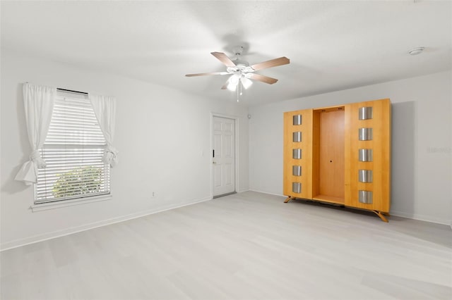 unfurnished room with light wood-type flooring and ceiling fan