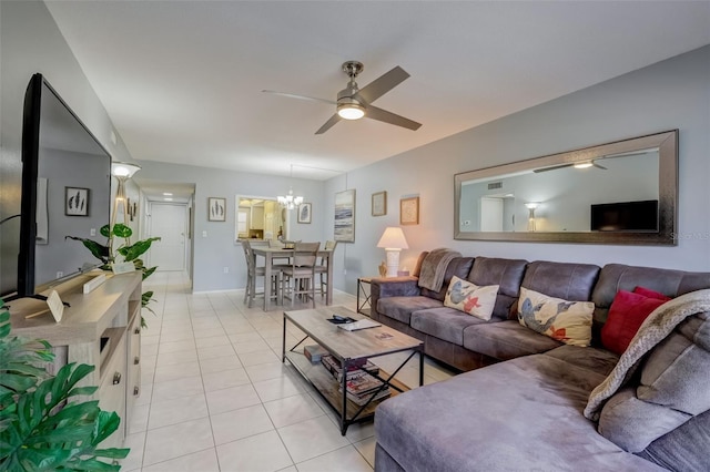 living room featuring ceiling fan with notable chandelier and light tile patterned floors