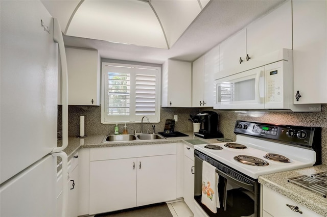 kitchen with sink, white cabinets, decorative backsplash, tile patterned floors, and white appliances