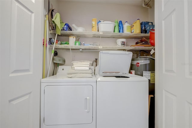 washroom with water heater and washer and dryer