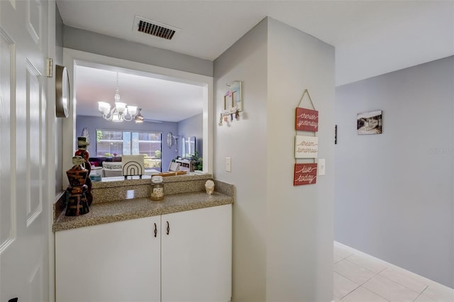 interior space featuring an inviting chandelier and light tile patterned flooring