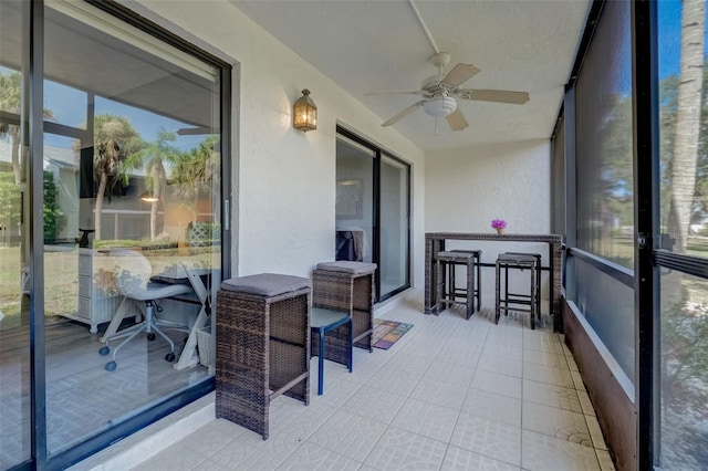 sunroom featuring ceiling fan