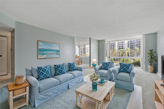 carpeted living room featuring expansive windows and a textured ceiling