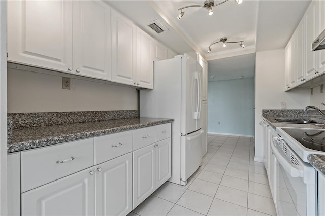 kitchen with sink, white appliances, light tile patterned floors, rail lighting, and white cabinets