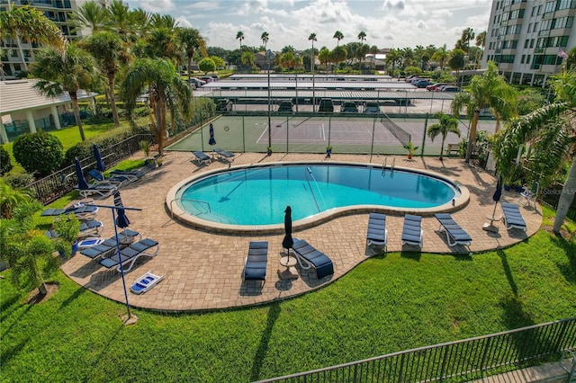 view of swimming pool featuring a yard and a patio area