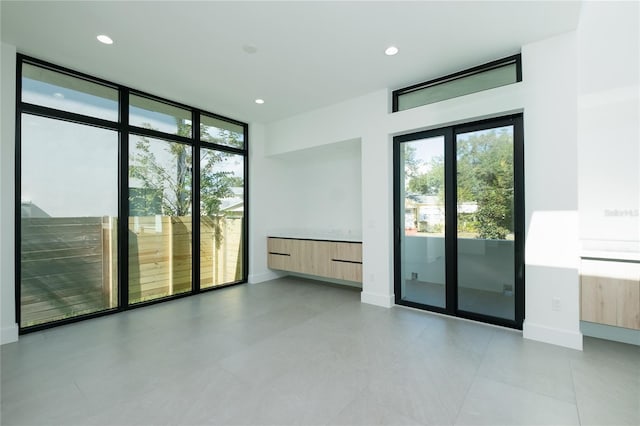 spare room featuring light tile patterned floors