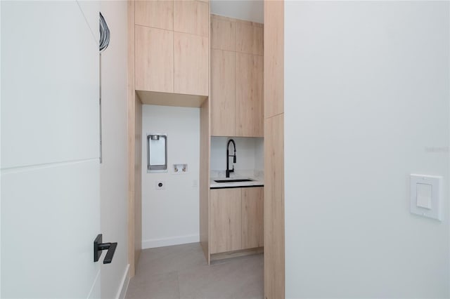 interior space with sink and light tile patterned flooring