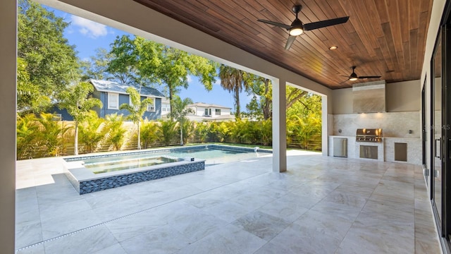 view of patio / terrace with a pool with connected hot tub, area for grilling, ceiling fan, and an outdoor kitchen