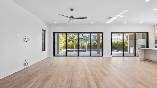 unfurnished living room featuring light wood-type flooring, baseboards, visible vents, and recessed lighting