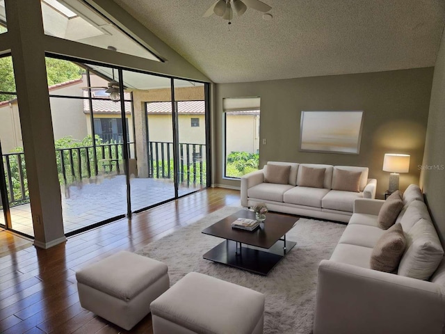 living room with hardwood / wood-style flooring, a healthy amount of sunlight, and ceiling fan