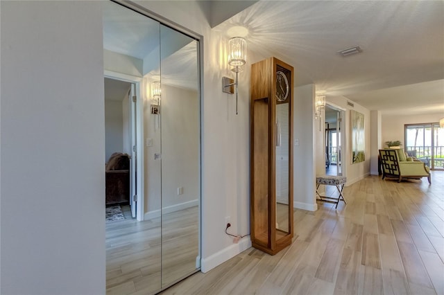 corridor with hardwood / wood-style flooring