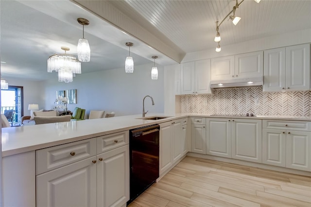 kitchen featuring white cabinetry, sink, black appliances, and hanging light fixtures