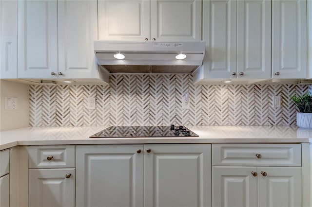 kitchen featuring white cabinetry, backsplash, and black electric cooktop