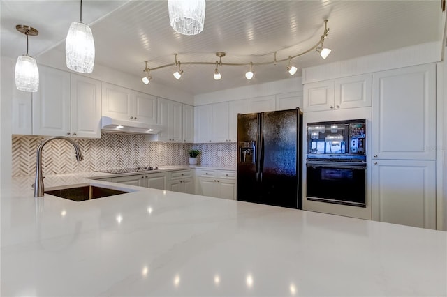 kitchen with sink, white cabinetry, tasteful backsplash, hanging light fixtures, and black appliances