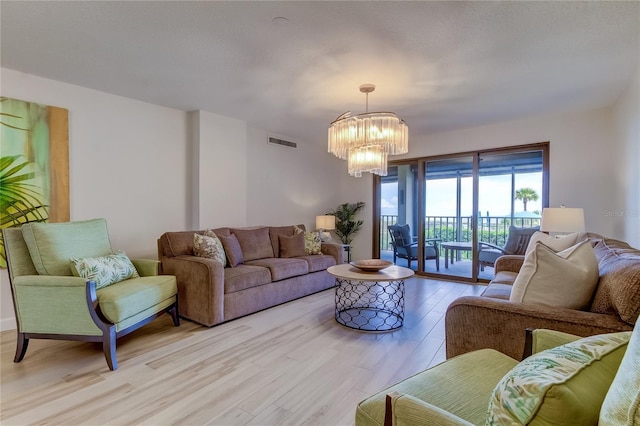 living room featuring light hardwood / wood-style flooring and a chandelier