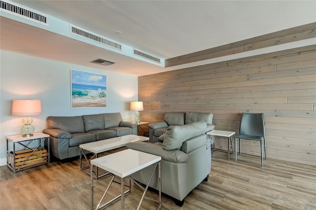 living room with hardwood / wood-style floors and wood walls