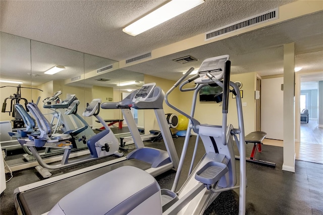 workout area featuring a textured ceiling