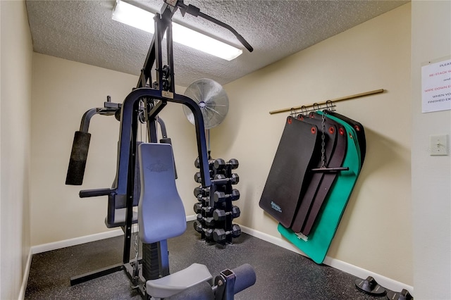 exercise area featuring a textured ceiling