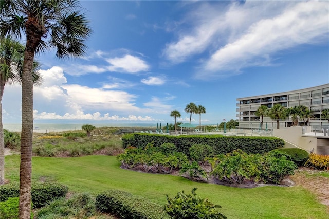 view of community with a water view and a lawn