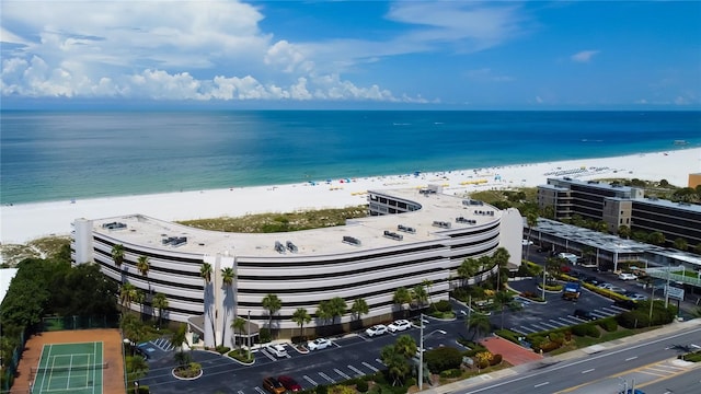 drone / aerial view featuring a water view and a beach view